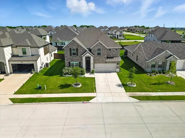 a house with green field in front of it