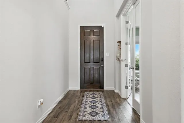 a view of hallway with wooden floor
