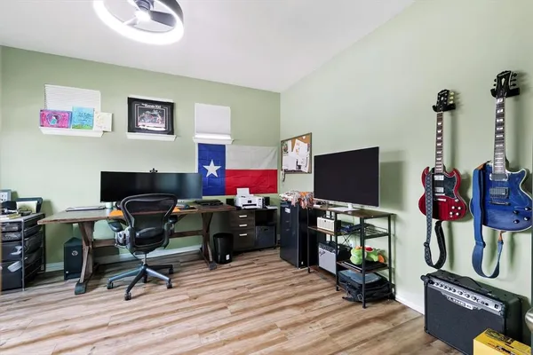 a view of a workspace with furniture and wooden floor