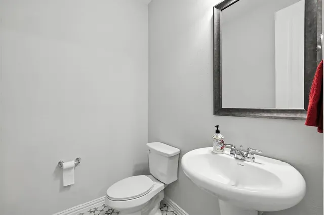 a bathroom with a sink a mirror and a toilet
