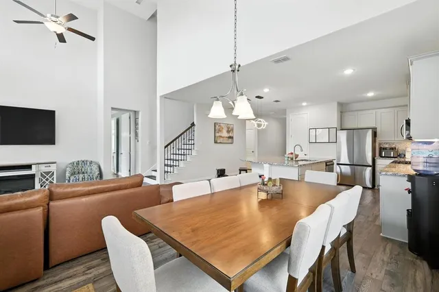 a dining room with furniture and wooden floor