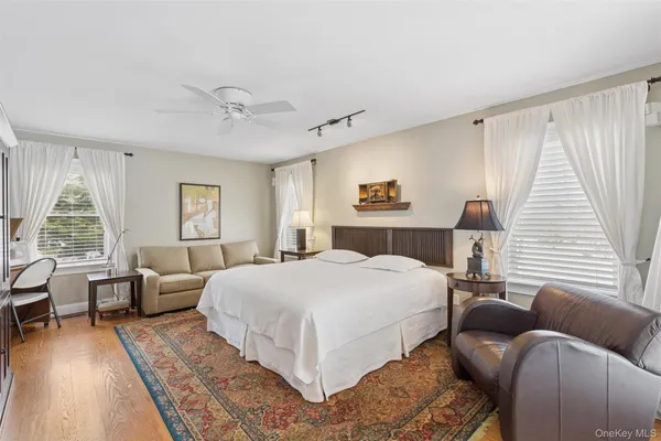 a bedroom with a large bed mirror and a window