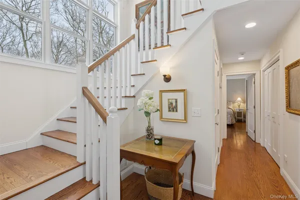 a view of entryway and hall with wooden floor