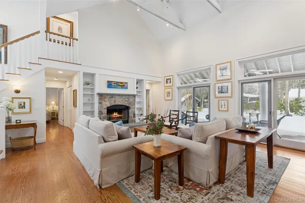 a living room with fireplace furniture and a large window