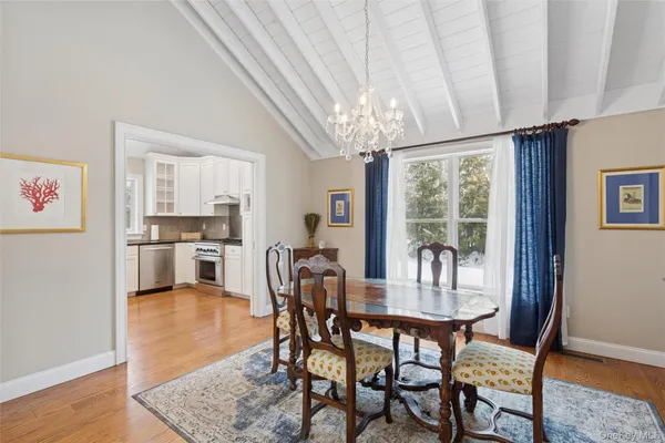 a view of a dining room with furniture wooden floor and chandelier