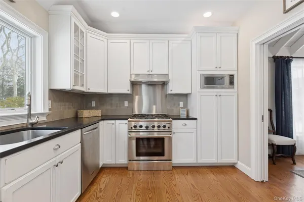 a kitchen with stainless steel appliances granite countertop a stove a refrigerator and a stove