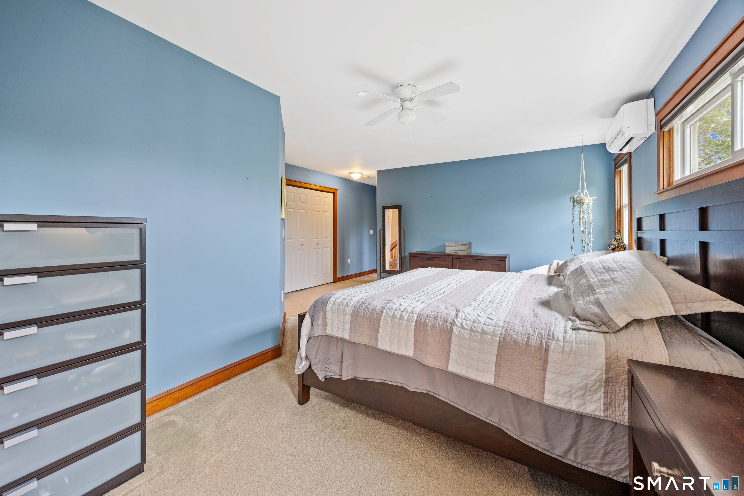 694 Millbrook Road Middletown, CT 06457 - Photo 21 of 34 a large bed sitting in a bedroom and a chandelier