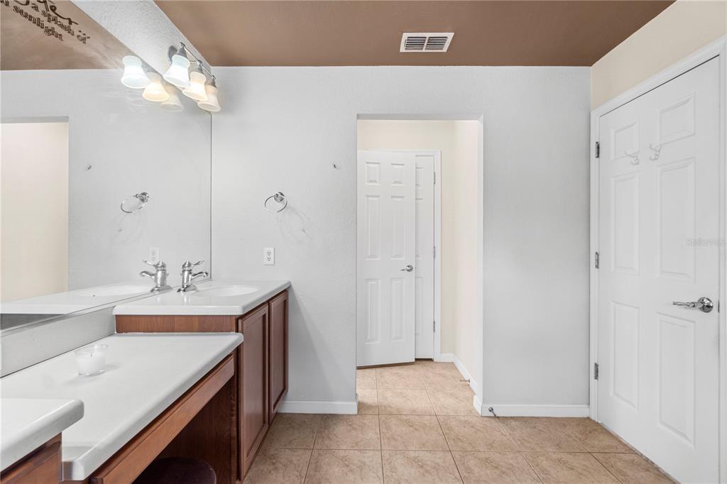 4199 Southwest 46th Court Ocala, FL 34474 - Photo 32 of 50 a bathroom with a sink a mirror and a shower