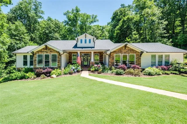 a front view of a house with garden