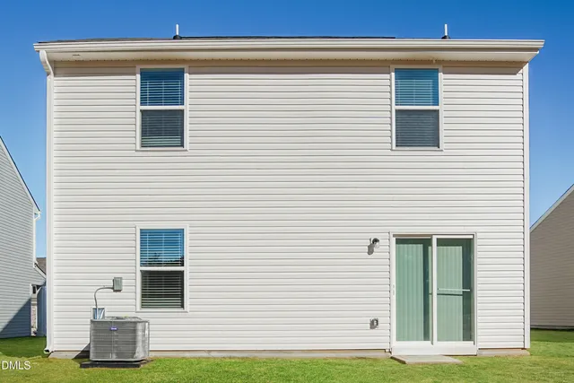 a view of a house with a yard and a porch