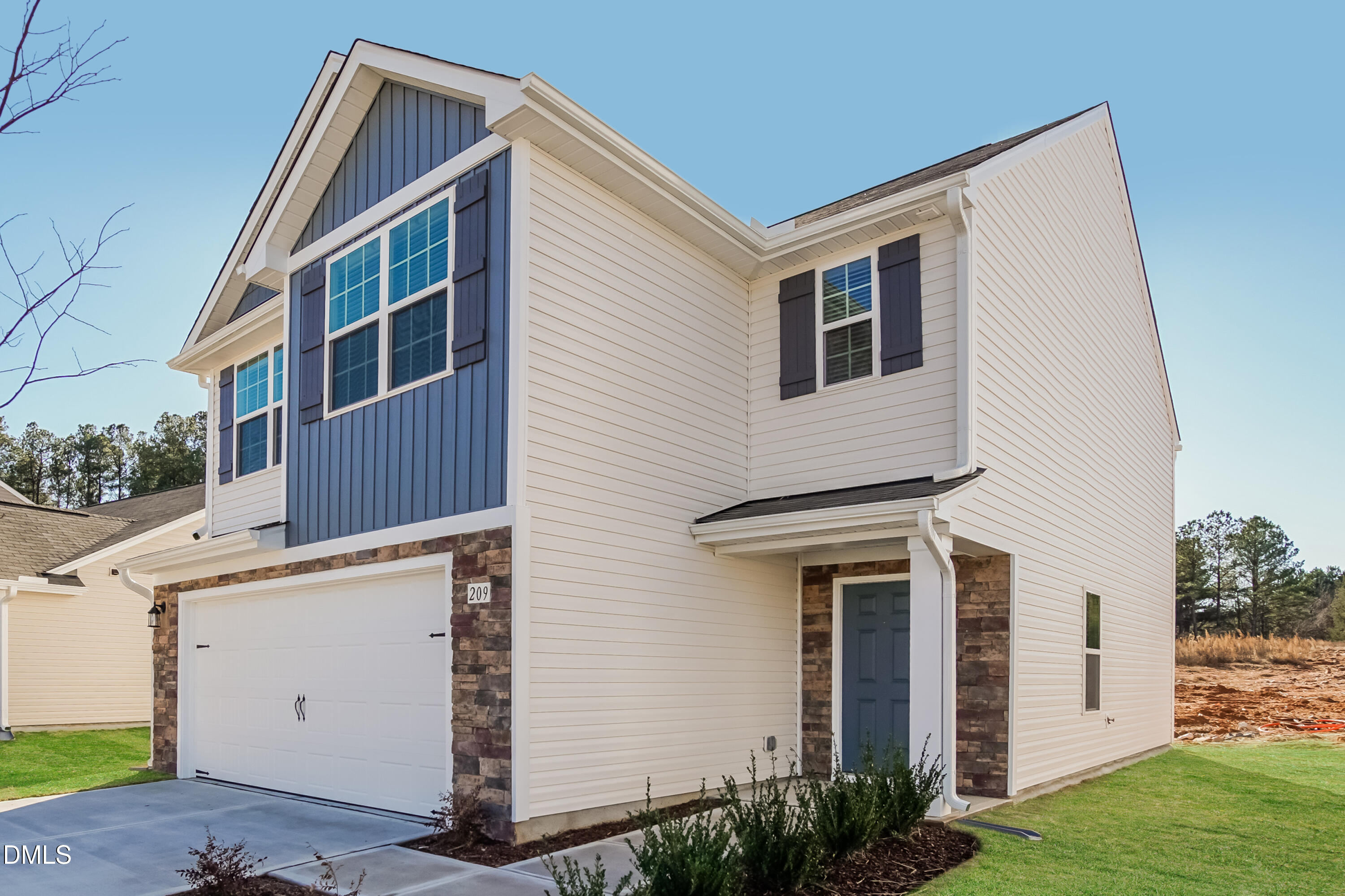 209 Indian Summer Street Zebulon, NC 27597 - Photo 2 of 17 a front view of a house with garden