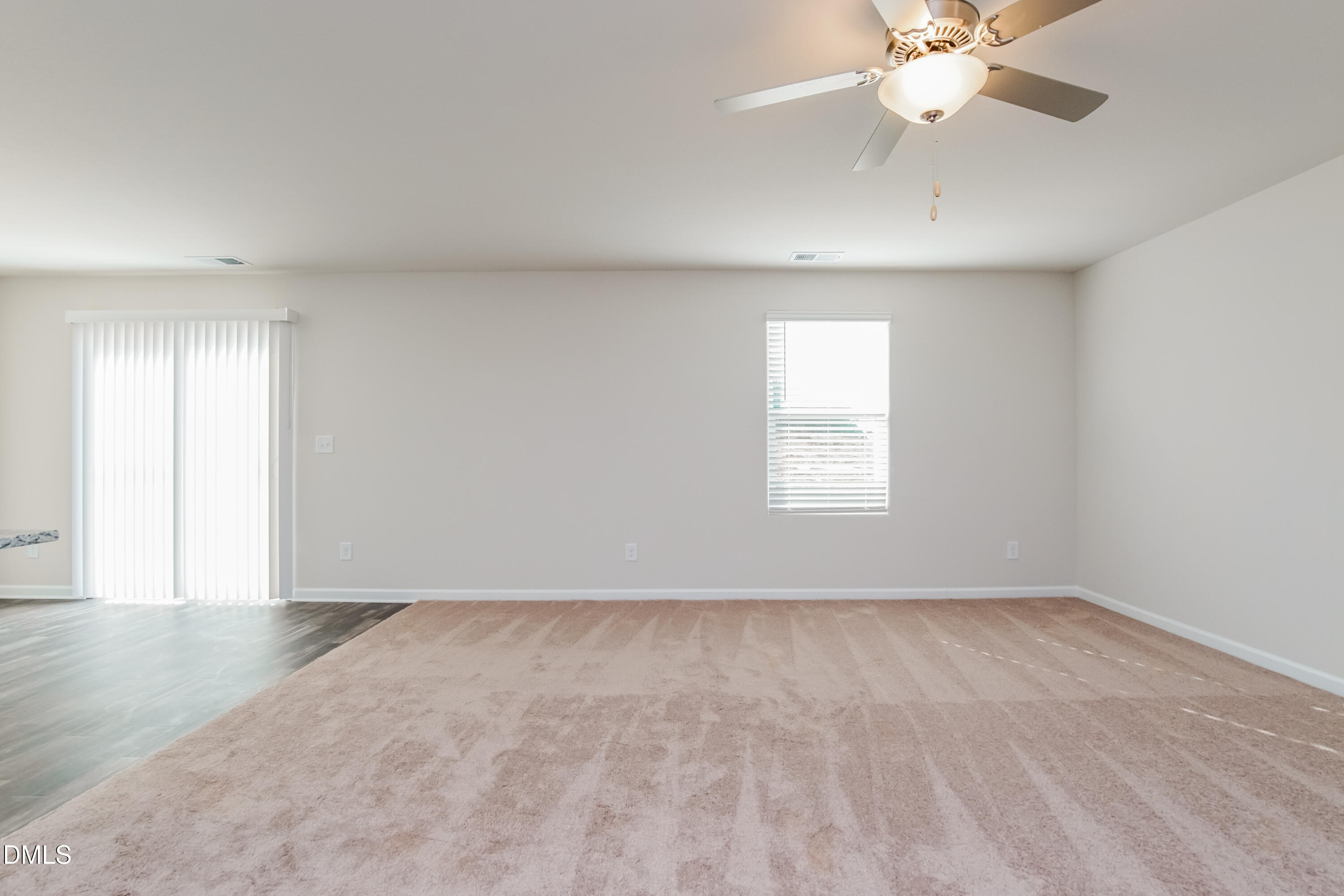 209 Indian Summer Street Zebulon, NC 27597 - Photo 5 of 17 wooden floor in an empty room with a window