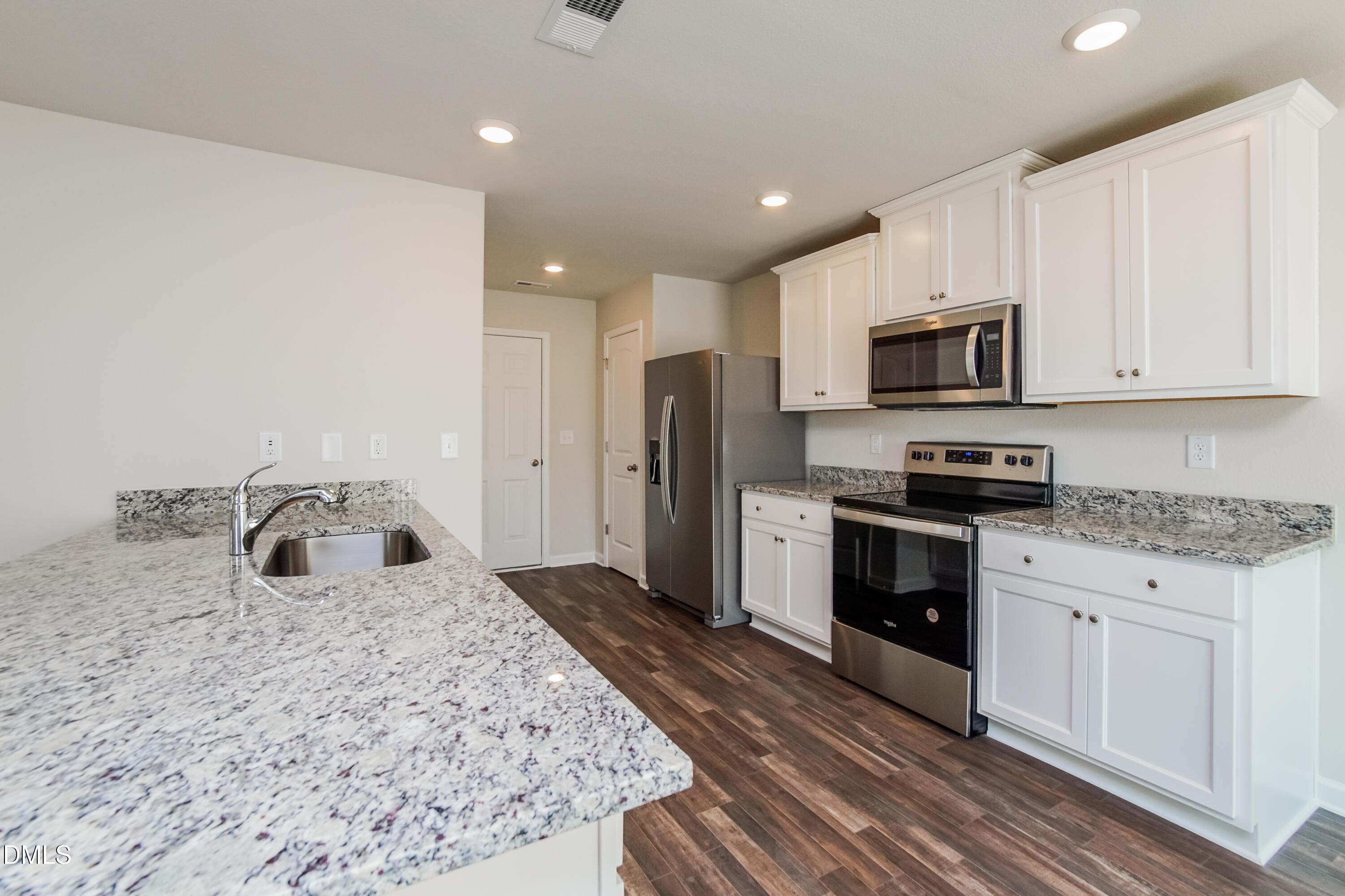 209 Indian Summer Street Zebulon, NC 27597 - Photo 6 of 17 a kitchen with kitchen island a sink stainless steel appliances and cabinets