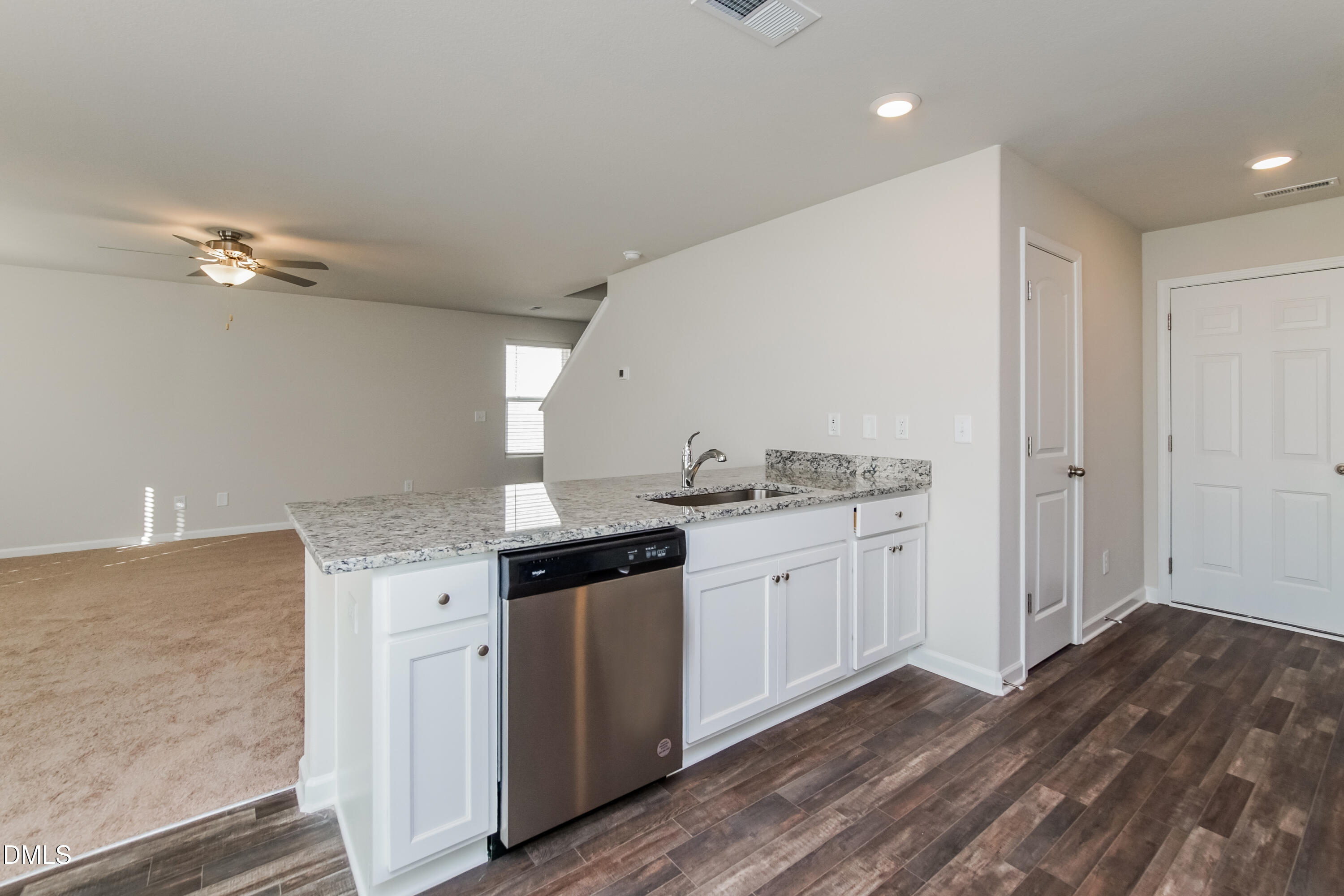 209 Indian Summer Street Zebulon, NC 27597 - Photo 7 of 17 a kitchen with granite countertop a sink cabinets and stainless steel appliances