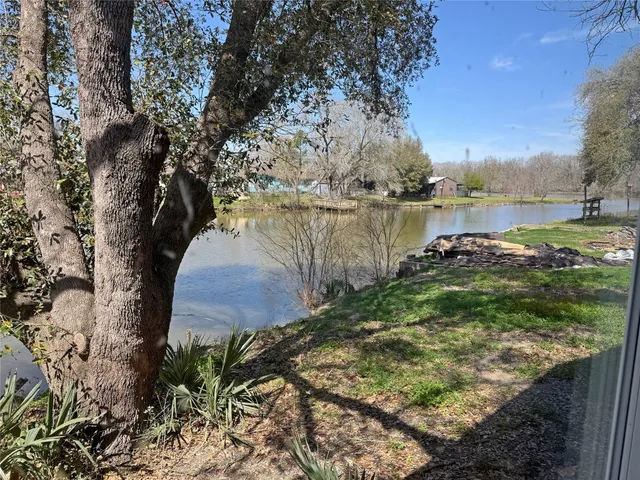 a view of a porch with wooden floor and a yard