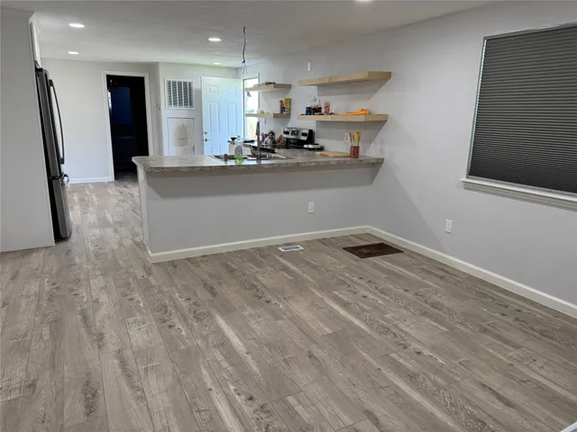 a kitchen with stainless steel appliances a refrigerator and a stove