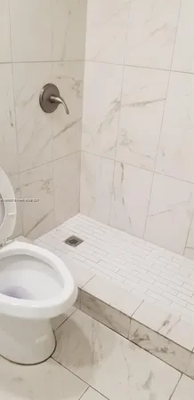 a bathroom with a bathtub and shower