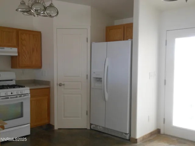 a kitchen with a refrigerator and a stove