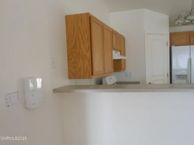 a view of a small space with wooden floor and a window
