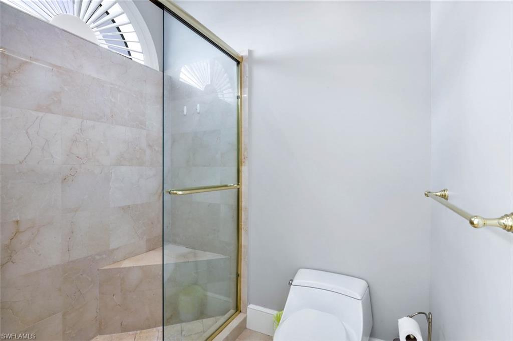 900 5th Avenue South, Unit 301 Naples, FL 34102 - Photo 12 of 17 a bathroom with a shower and toilet