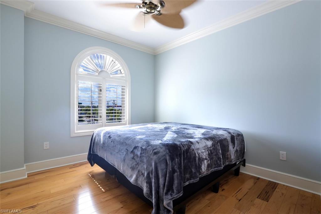 900 5th Avenue South, Unit 301 Naples, FL 34102 - Photo 13 of 17 a bedroom with a bed and a large window