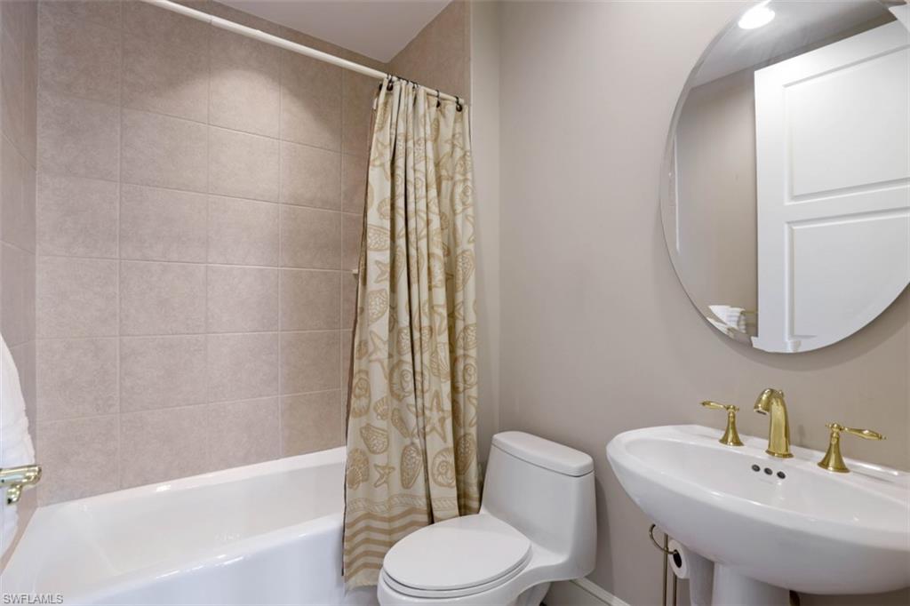 900 5th Avenue South, Unit 301 Naples, FL 34102 - Photo 14 of 17 a bathroom with a sink toilet and bathtub