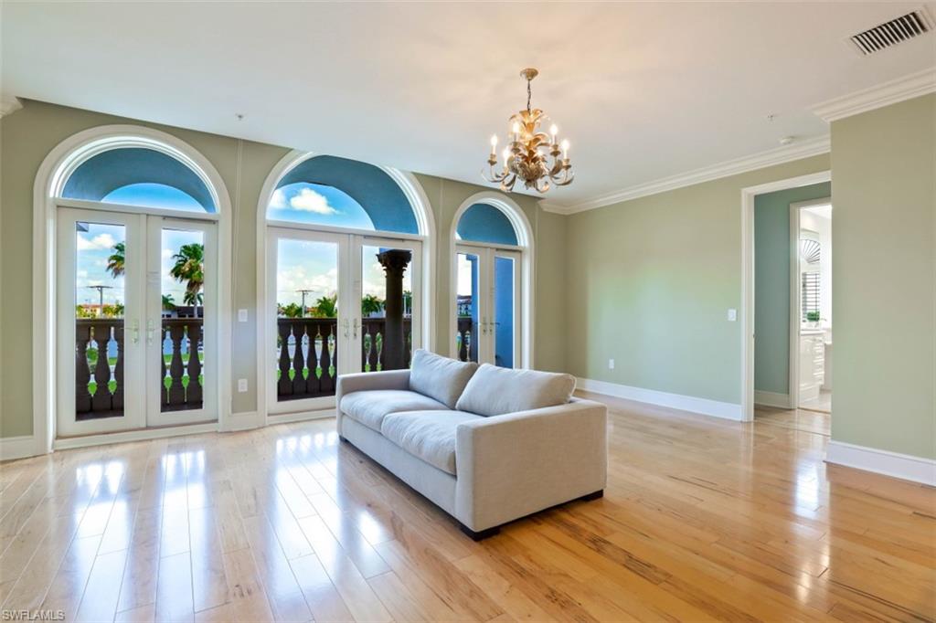 900 5th Avenue South, Unit 301 Naples, FL 34102 - Photo 2 of 17 a living room with furniture and a large window