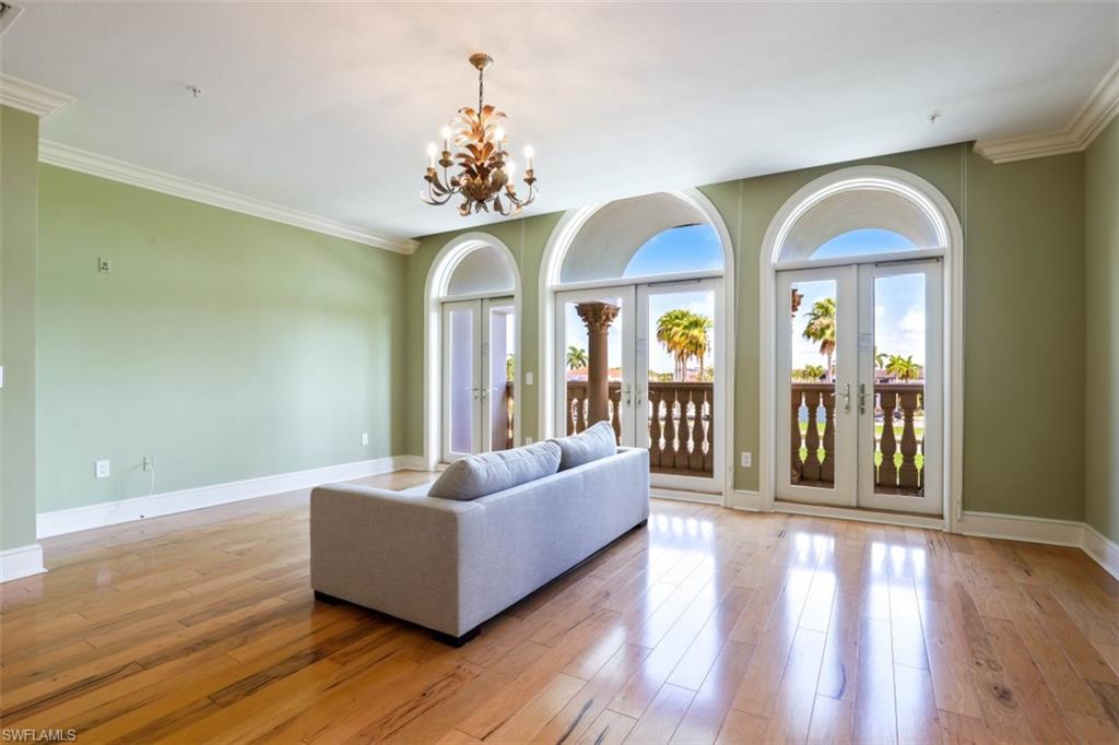 900 5th Avenue South, Unit 301 Naples, FL 34102 - Photo 3 of 17 a living room with furniture and a chandelier