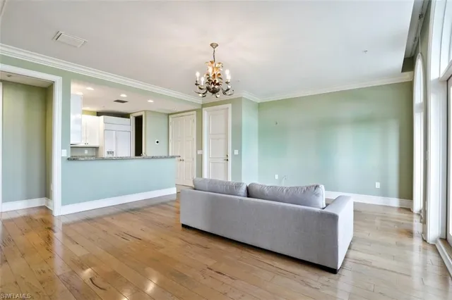 a living room with furniture and a chandelier