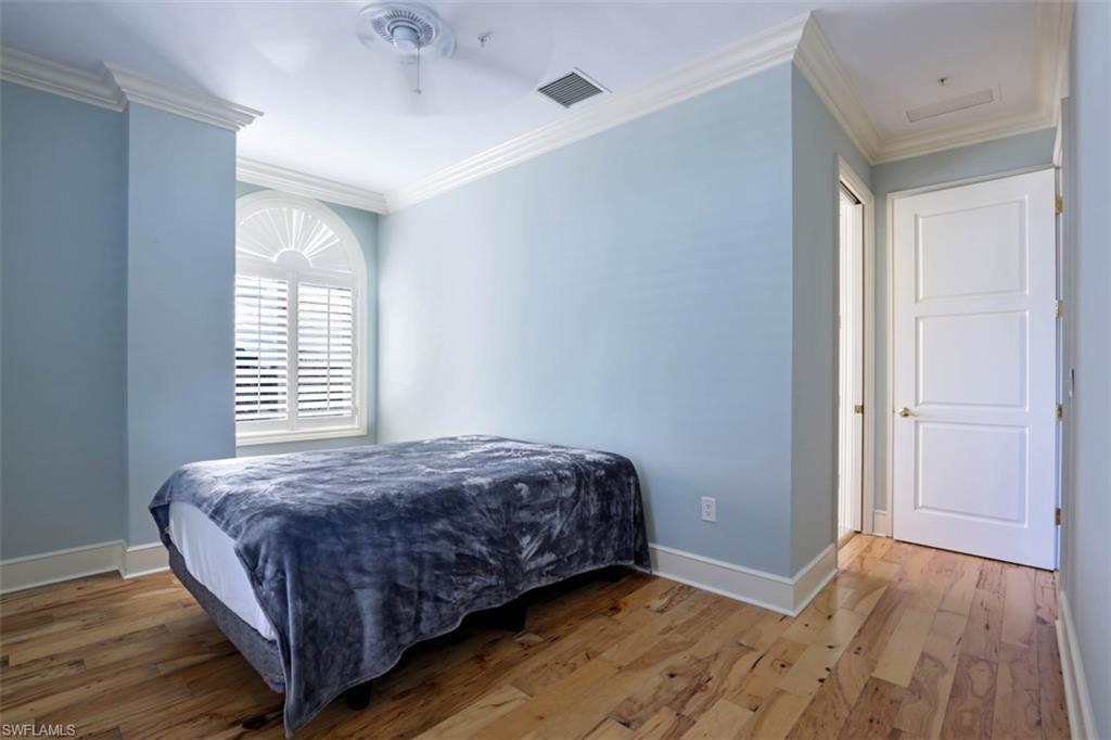 900 5th Avenue South, Unit 301 Naples, FL 34102 - Photo 9 of 17 a bedroom with a bed and a window
