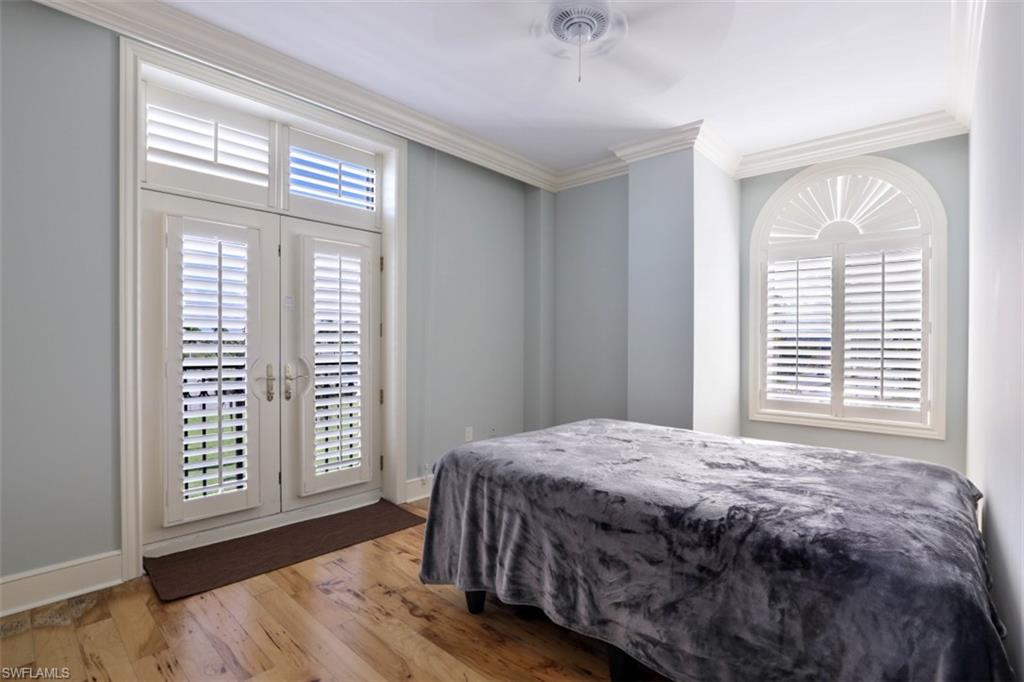 900 5th Avenue South, Unit 301 Naples, FL 34102 - Photo 10 of 17 a bedroom with a bed and a window