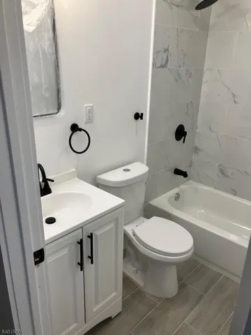 a bathroom with a toilet sink and a bathtub
