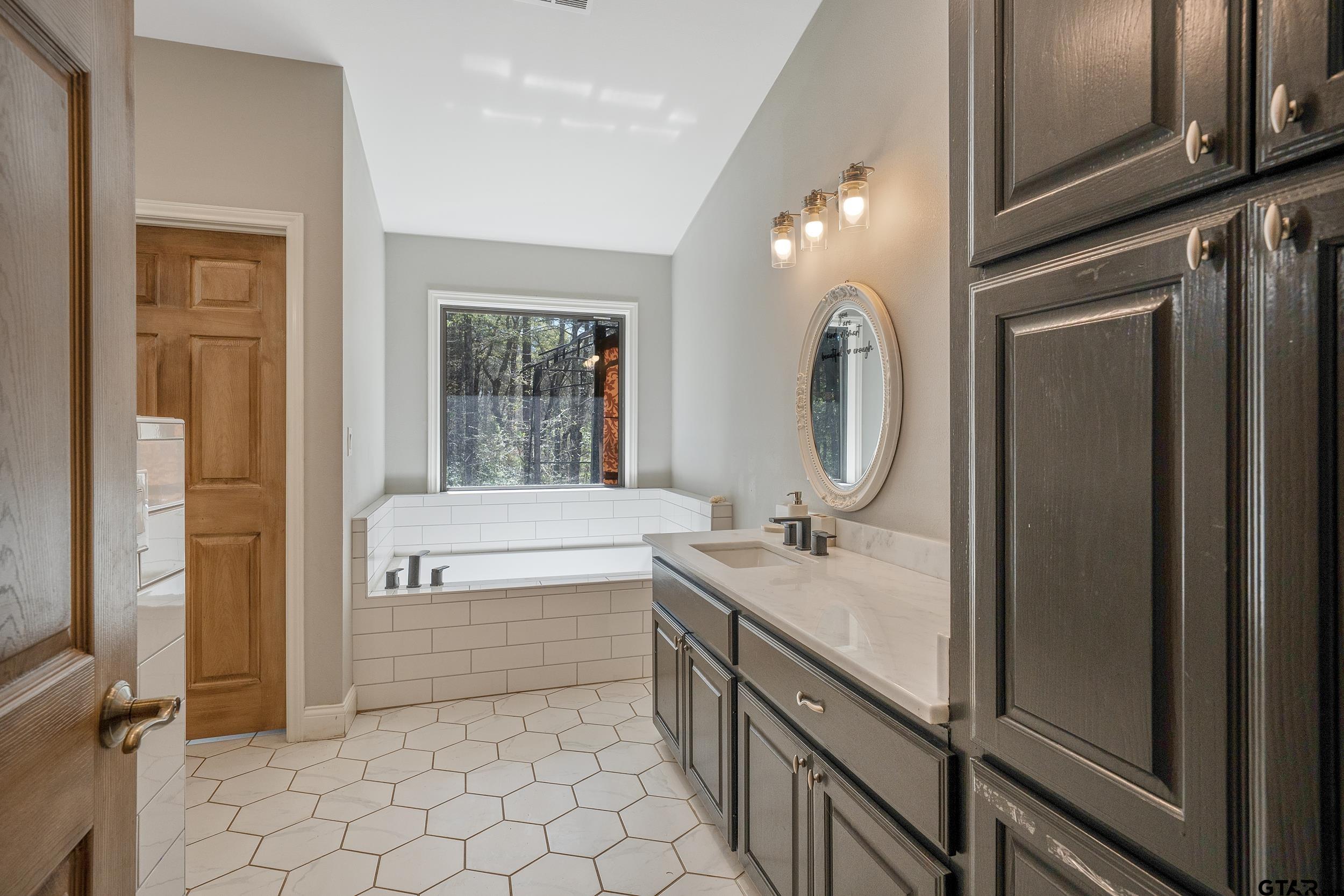 3481 Loop 343 Rusk, TX 75785 - Photo 40 of 48 a bathroom with a granite countertop sink a toilet and a mirror