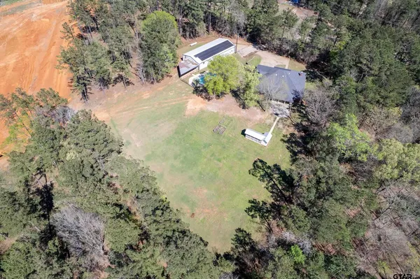 an aerial view of a house with a yard