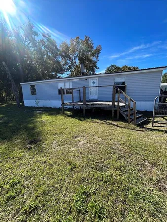 a view of a backyard with sitting area