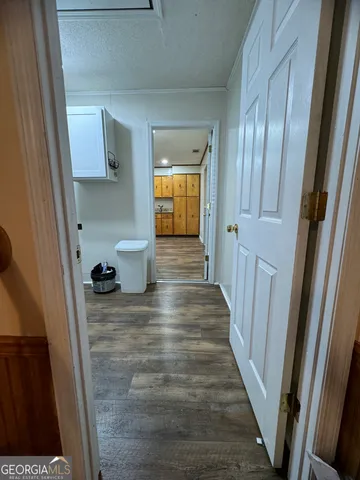 a view of hallway with wooden floor