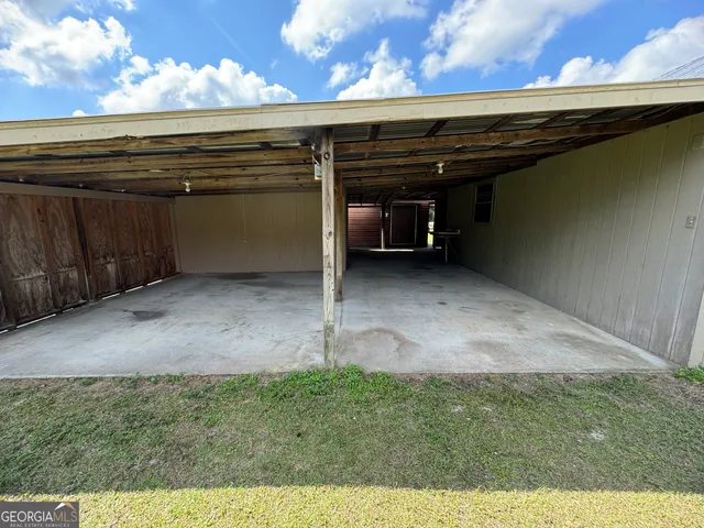 a view of a field with an trees in the background