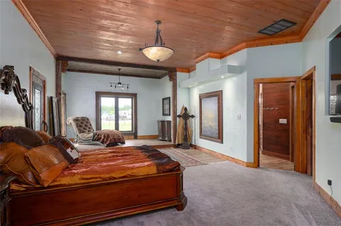 a en suite bathroom with a granite countertop sink and a mirror