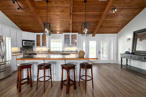 a hallway with a couch and chandelier