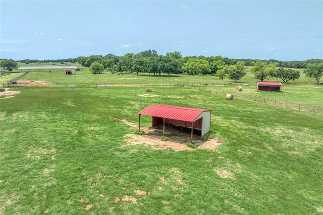 a backyard of a house with a yard and outdoor seating