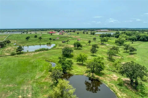 a view of grassy field with trees