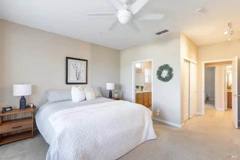 a bedroom with a large bed and a chandelier