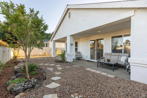 a view of a house with backyard and sitting area