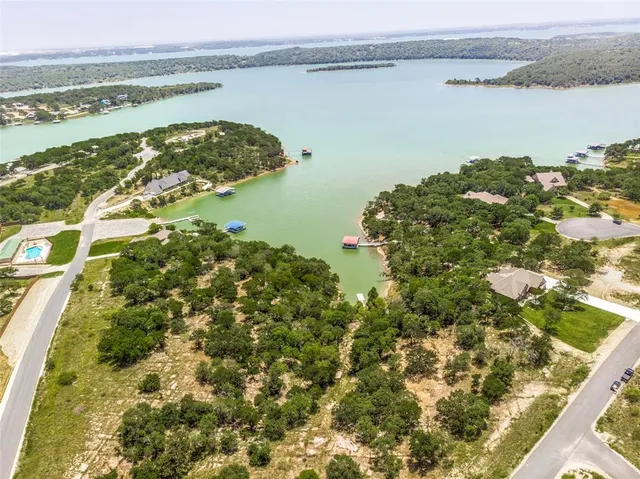 an aerial view of a house with a yard basket ball court