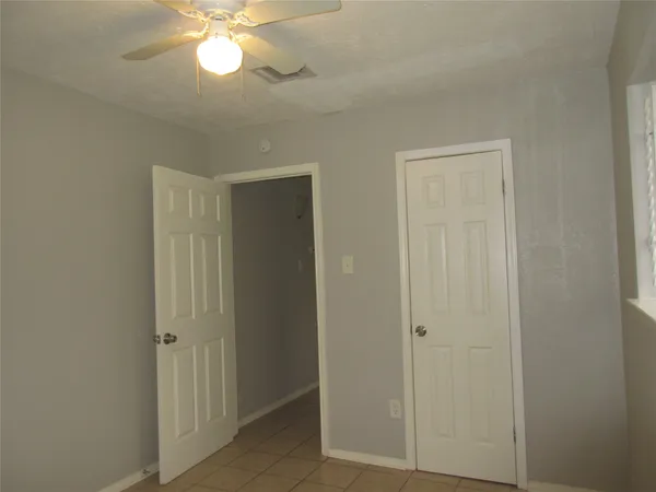 a view of a livingroom with a chandelier fan