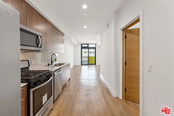 a kitchen with stainless steel appliances granite countertop a stove and a sink