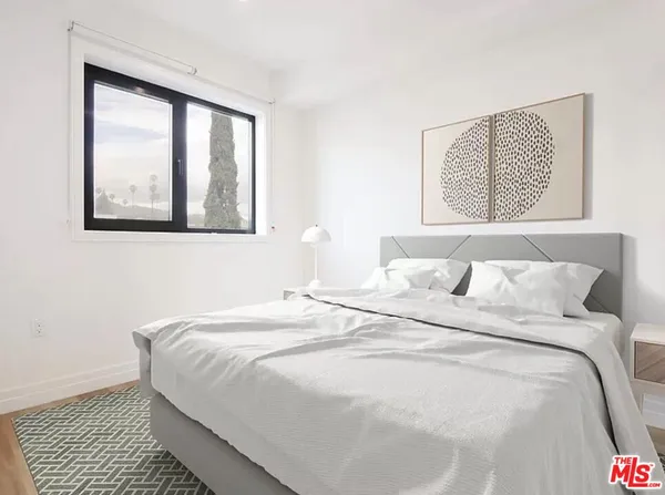 a bedroom with a bed and a window