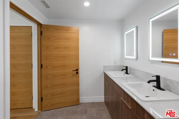 a bathroom with a sink a vanity and a mirror