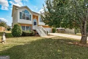 a front view of a house with a yard