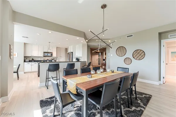 a view of a dining room with furniture and wooden floor